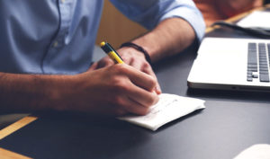 Stock photo that we will assume is someone writing down his 2018 goals.