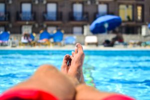 Someone putting their feet up by the pool.