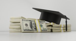 Graduation cap and a bunch of money representing the student loans we owed.